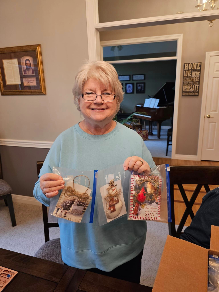 Connie Thompson holding some of her ornaments.