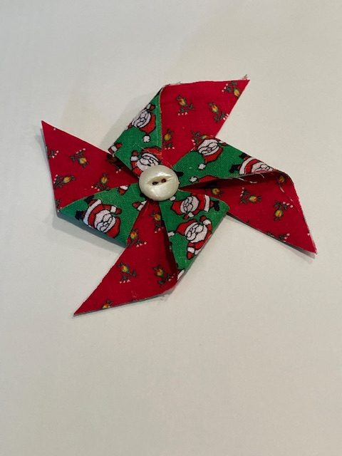 A pinwheel made of fabric and a single button. Don't forget the hanger!