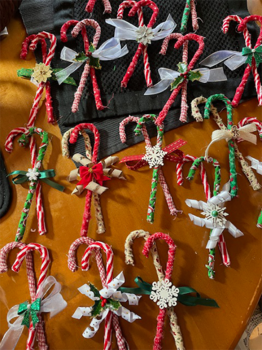 An ornament made by wrapping some fabric around a candy cane shape.