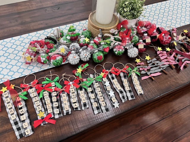 Ornaments made from Scrabble tiles glued onto a strip of fabric that spell out various sayings.