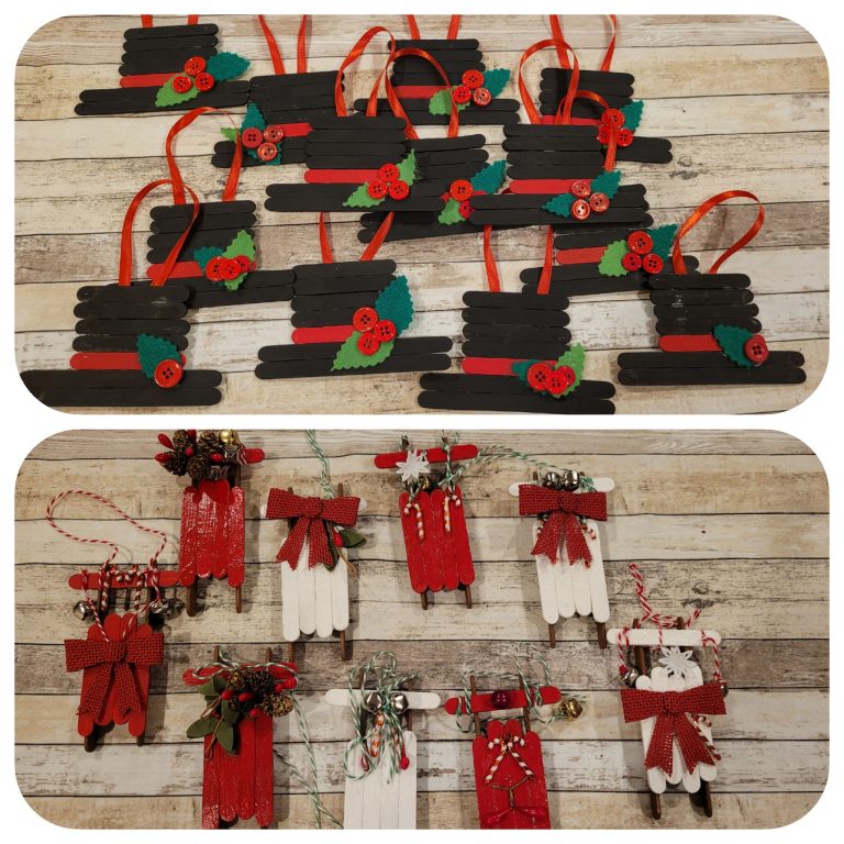 Ornaments made from popsicle sticks in the shape of a top hat and snow sleds.