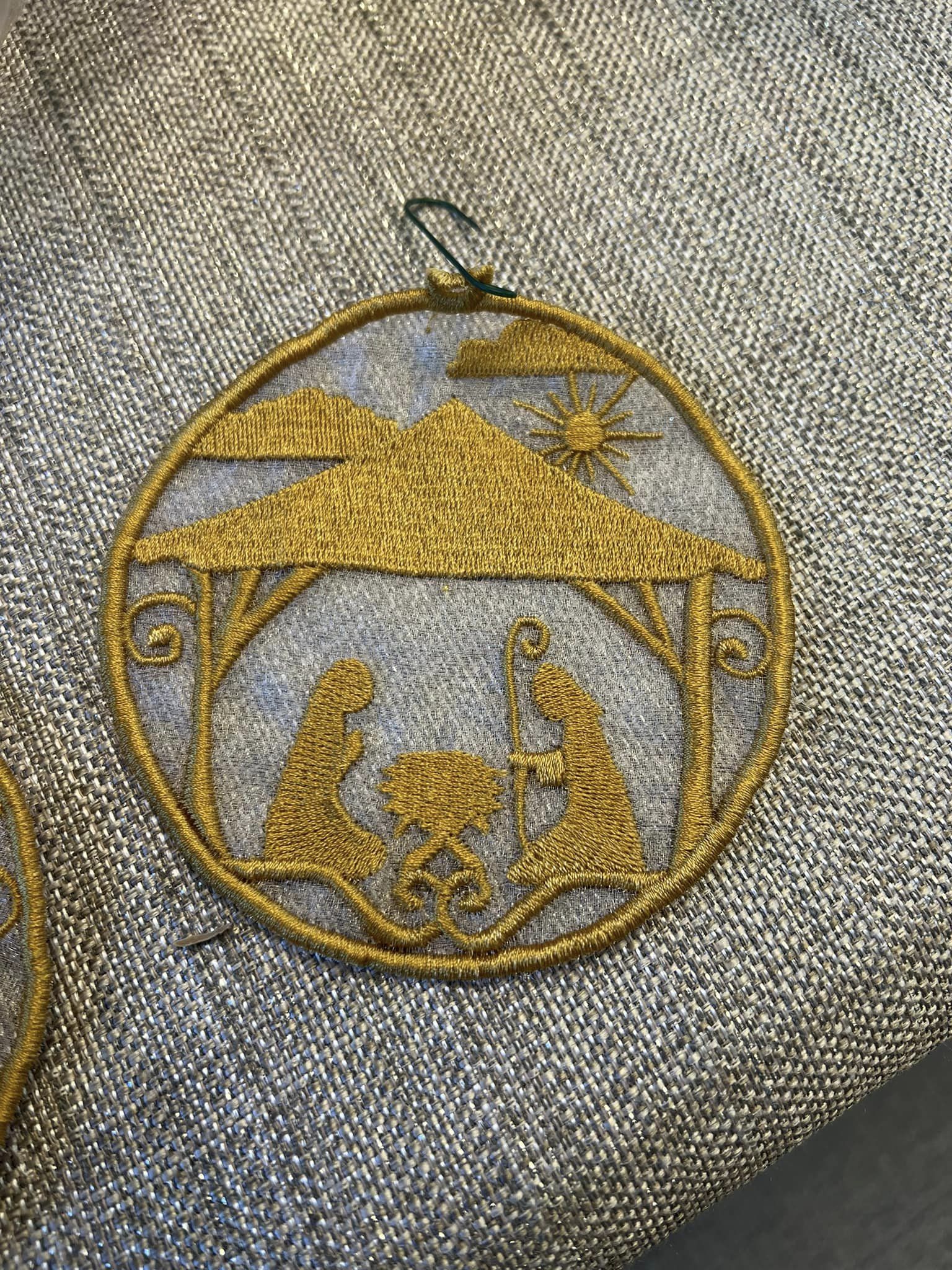 This embroidery on a clear fabric background depicts the nativity scene.