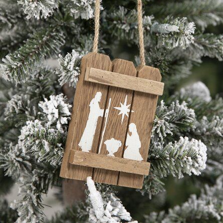 Wooden blocks shaped like a fence with a nativity scene painted or stamped onto it.